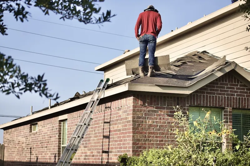 Professional roofer working on a residential roof in Brightwaters